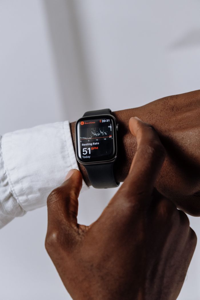 Close-up of a digital smartwatch displaying a health app on a person's wrist, emphasizing modern technology.